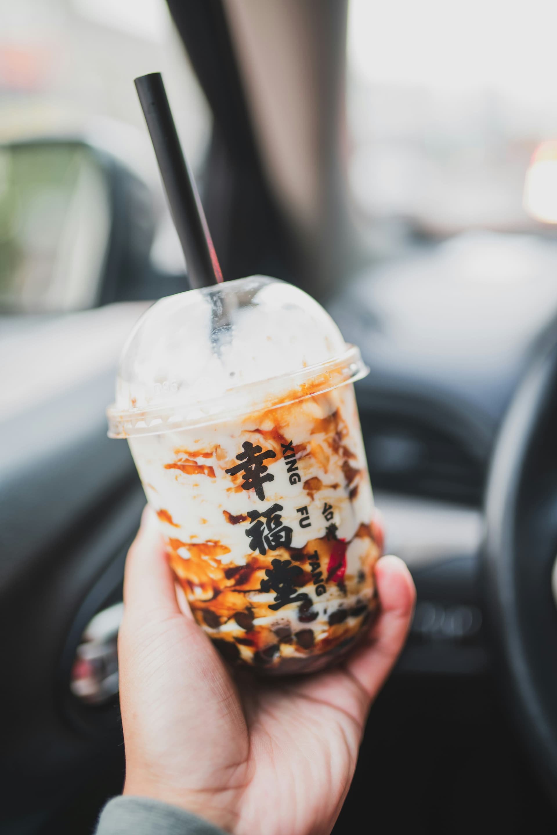 A person holding a Taiwanese bubble tea