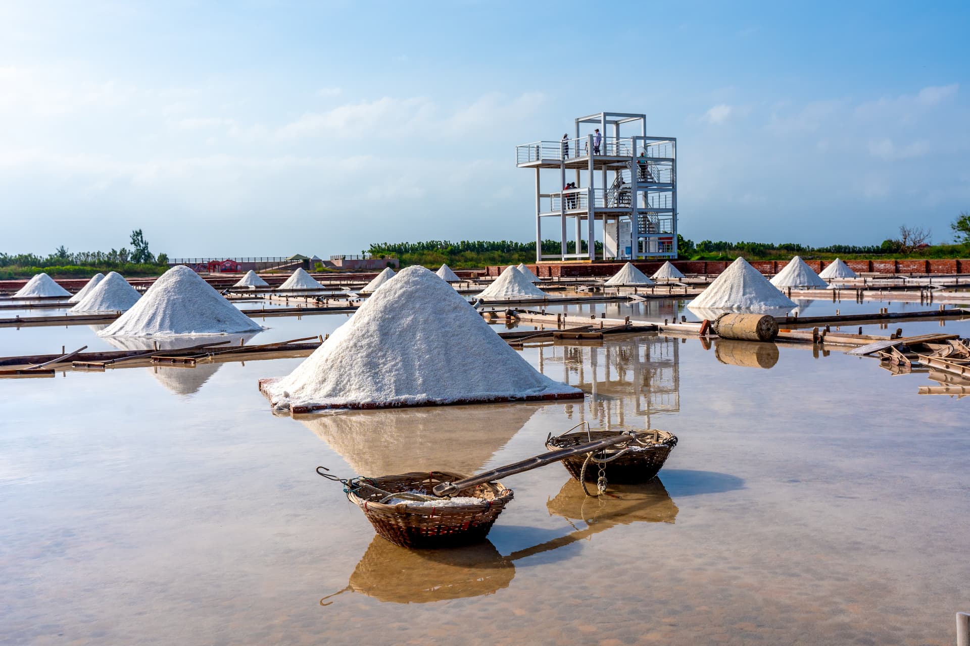 Jingzaijiao Tile-Paved Salt Fields with cone-shaped salt piles on shallow water