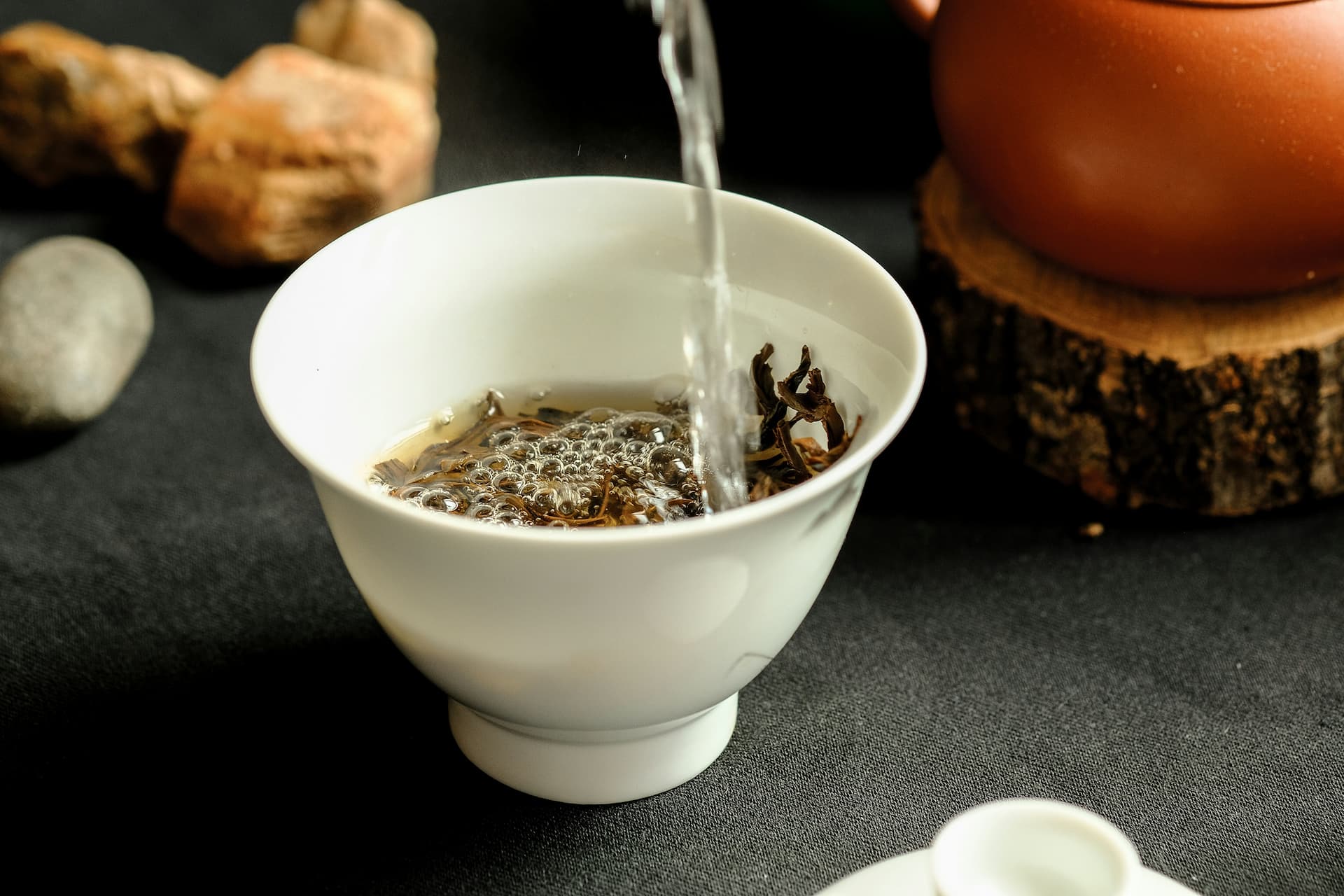 Tea leaves being brewed in a tea cup